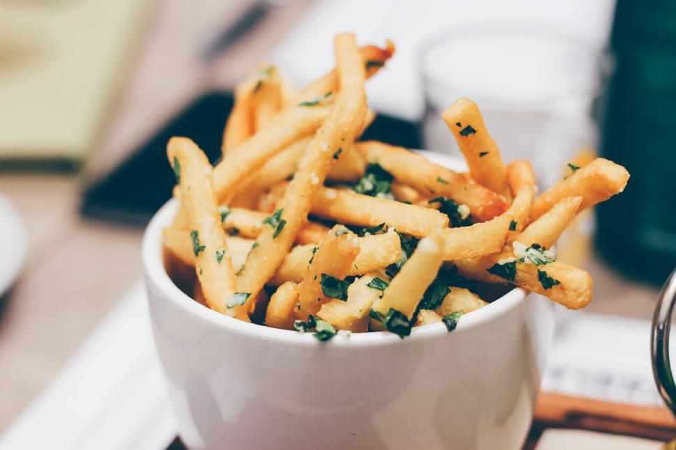 Free Image of Close-up of herb-seasoned French fries in a white bowl 