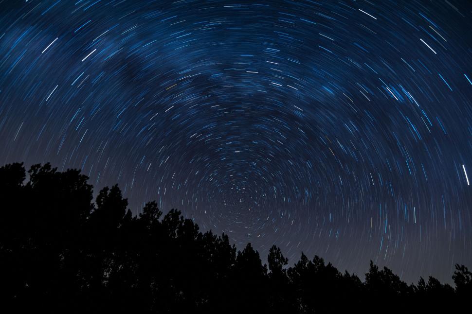 Free Image of Star trails create a spiral pattern in the night sky 