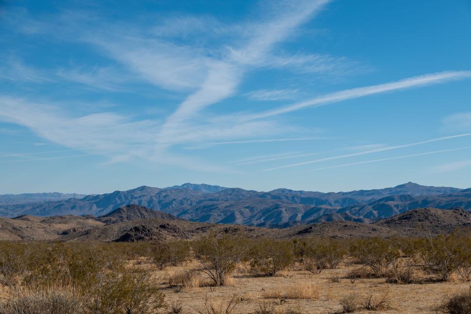 Free Image of Vast desert landscape with mountains and clear sky. 