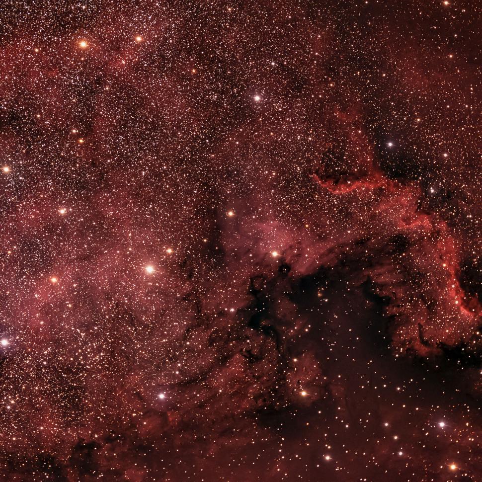 Free Image of Vast starry nebula in the night sky with red hues 