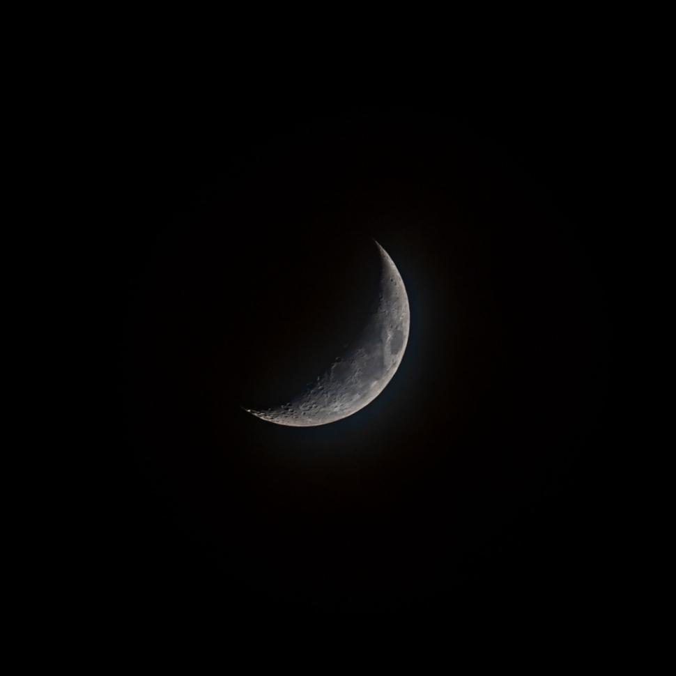 Free Image of Crescent moon glowing softly against the night sky. 