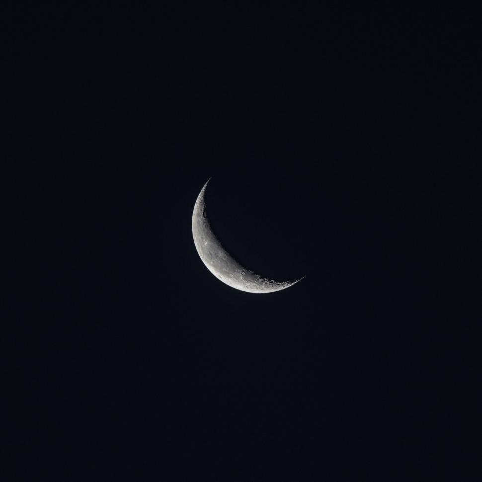 Free Image of Crescent moon glowing in the dark night sky. 