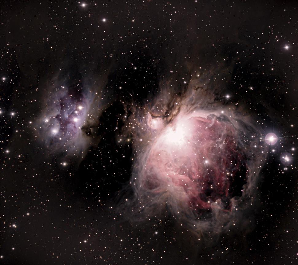 Free Image of Orion Nebula with vivid colors in a vast star-filled space 