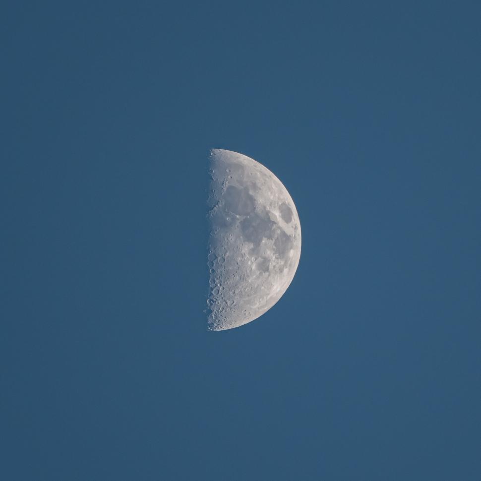 Free Image of Half Moon against a dusk blue and serene sky 