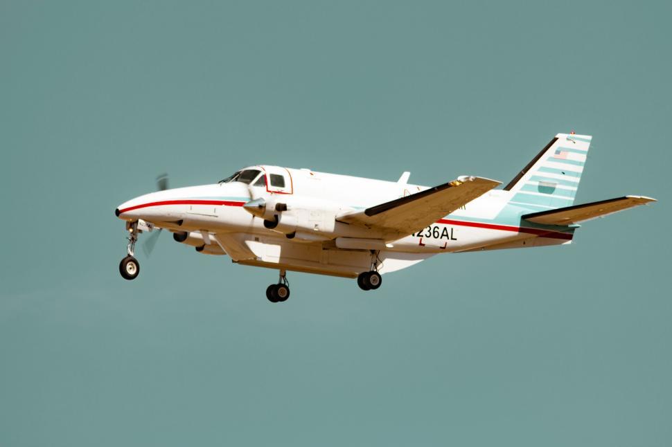 Free Image of Passenger airplane with landing gear deployed, mid-flight 
