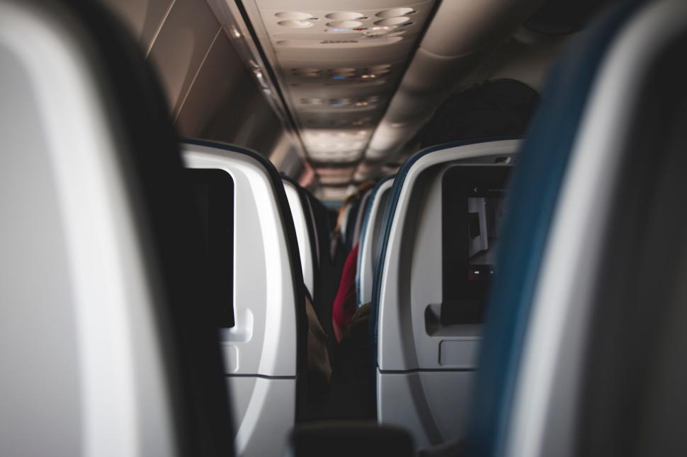 Free Image of Airplane cabin view with passenger seats 