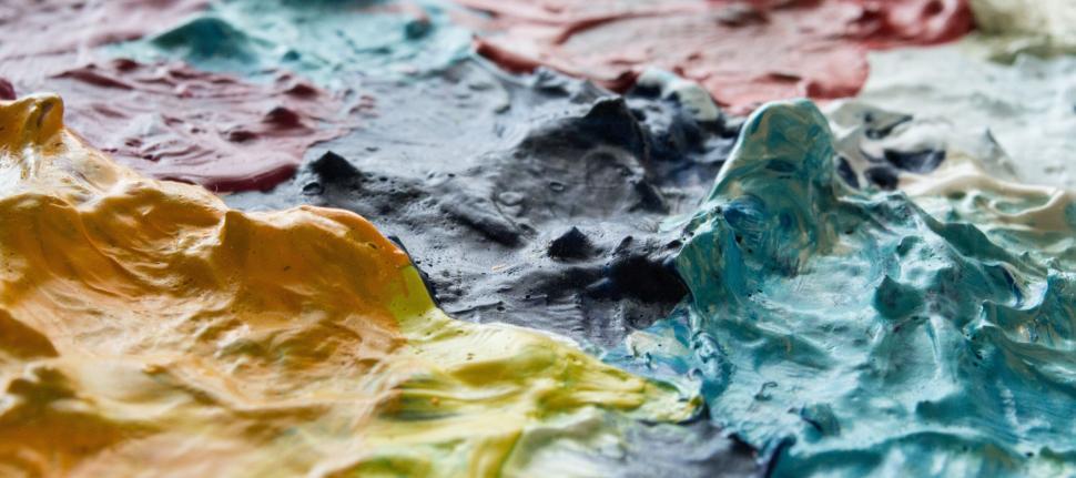 Free Image of Thick layers of colorful paint creating rich textures. 