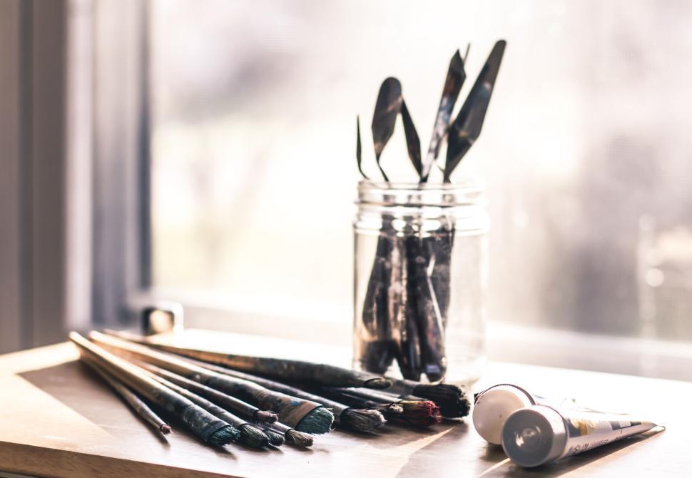 Free Image of Jar of brushes and painting tools on wooden table. 