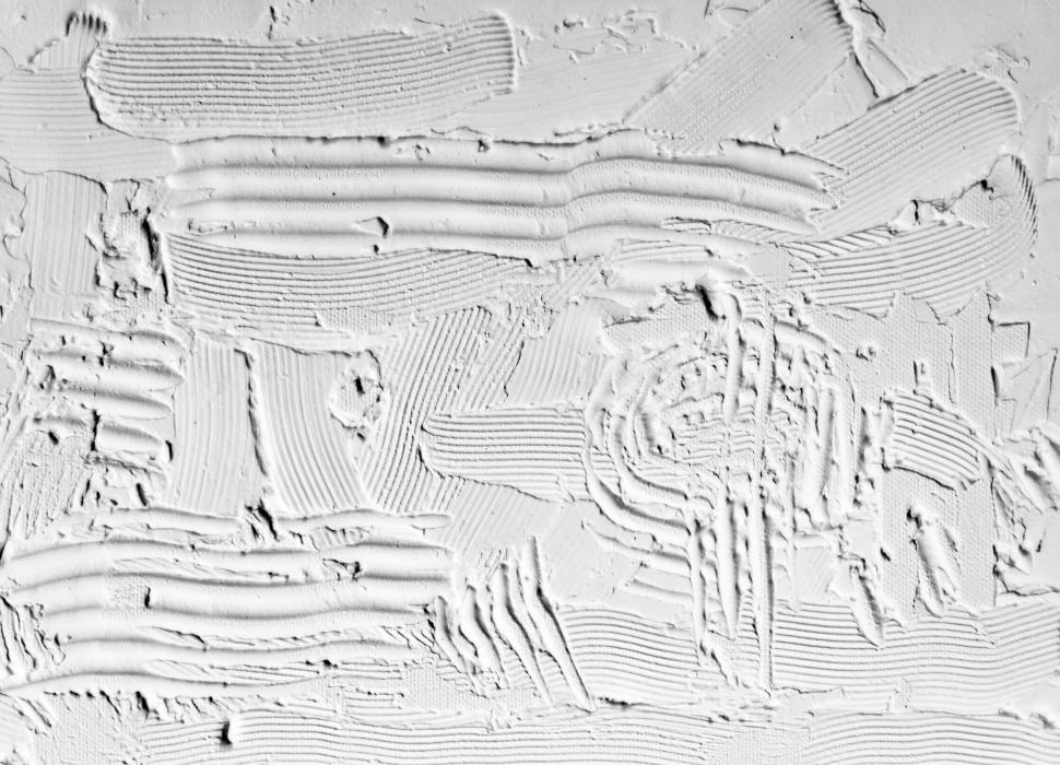 Free Image of Textured white plaster with intricate engraved patterns. 