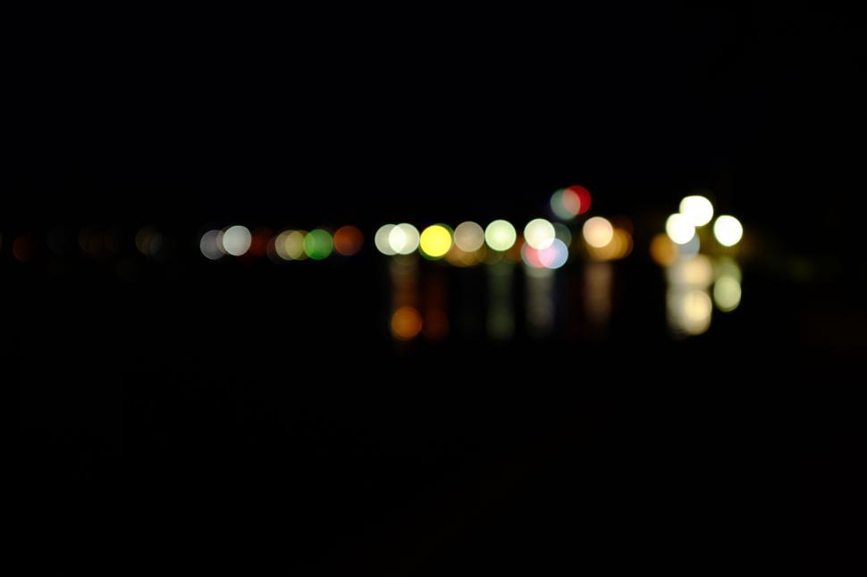 Free Image of Abstract nightlights on a dark reflective surface 