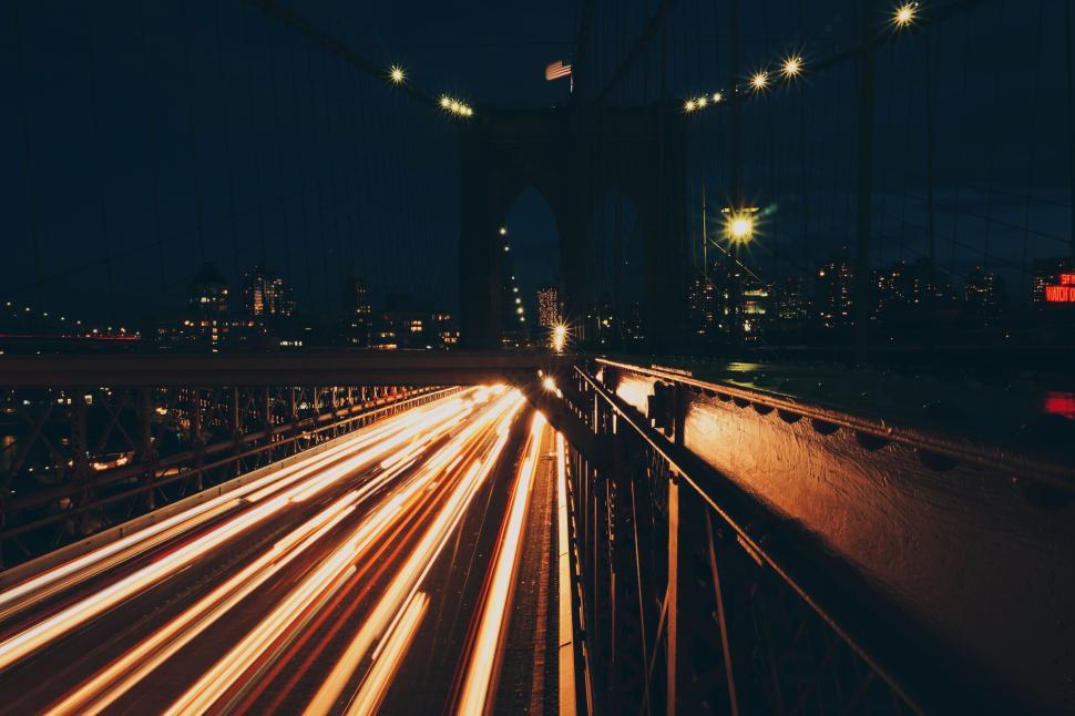Free Image of Long exposure bridge with light trails at night view 