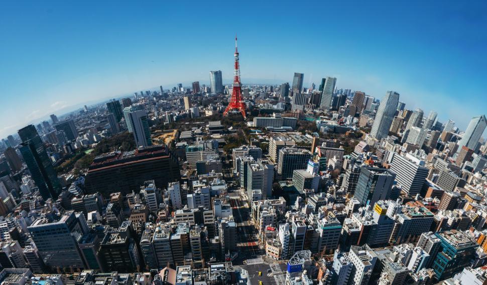 Free Image of Urban skyline with a prominent red tower stands tall 