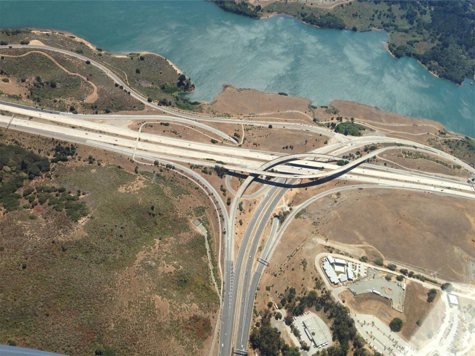 Free Image of Aerial view of a highway interchange by the water 