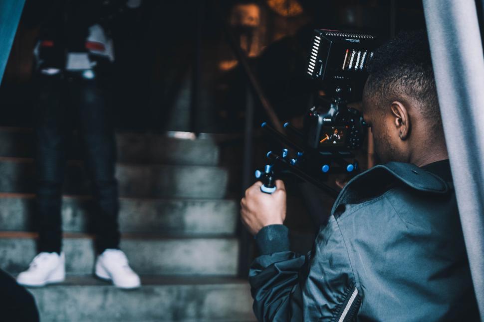 Free Image of Person filming with professional camera on stairs 