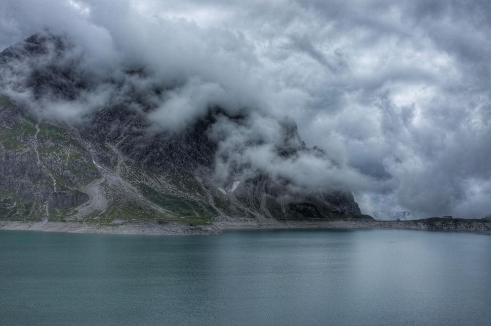 Free Image of Foggy mountain landscape embracing a tranquil lake 