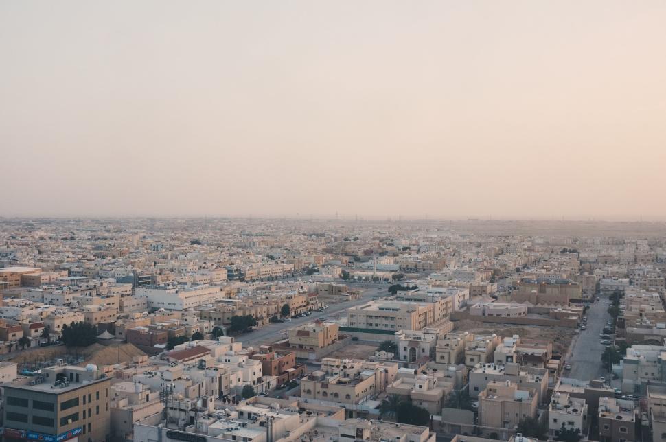 Free Image of Expansive cityscape of urban buildings under sunset light 
