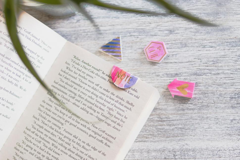 Free Image of Book with colorful bookmarks on a wooden table 