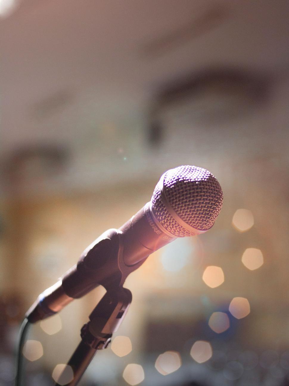 Free Image of Close-up of microphone in warm ambient lighting. 