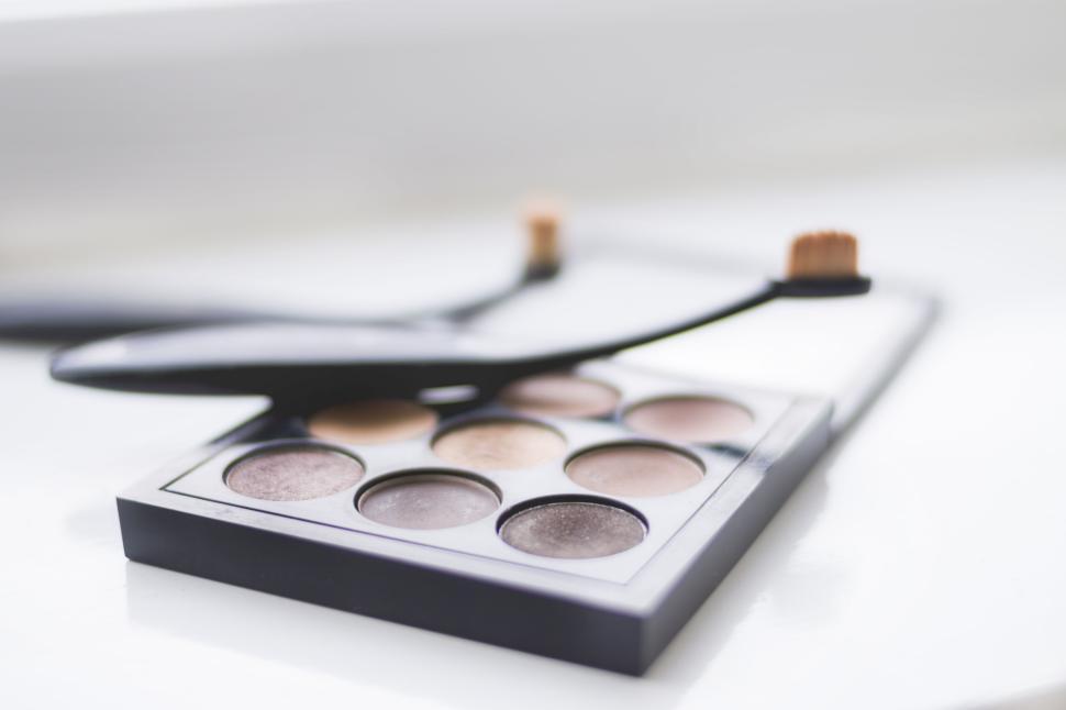 Free Image of Makeup palette with brushes on a white surface 