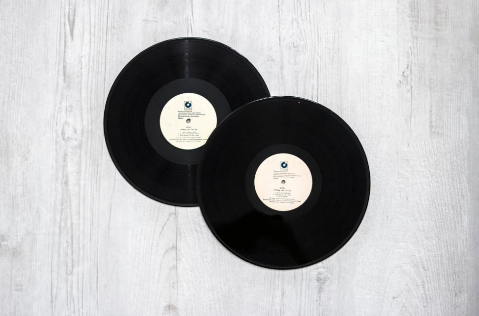 Free Image of Two vinyl records on a light wooden background 