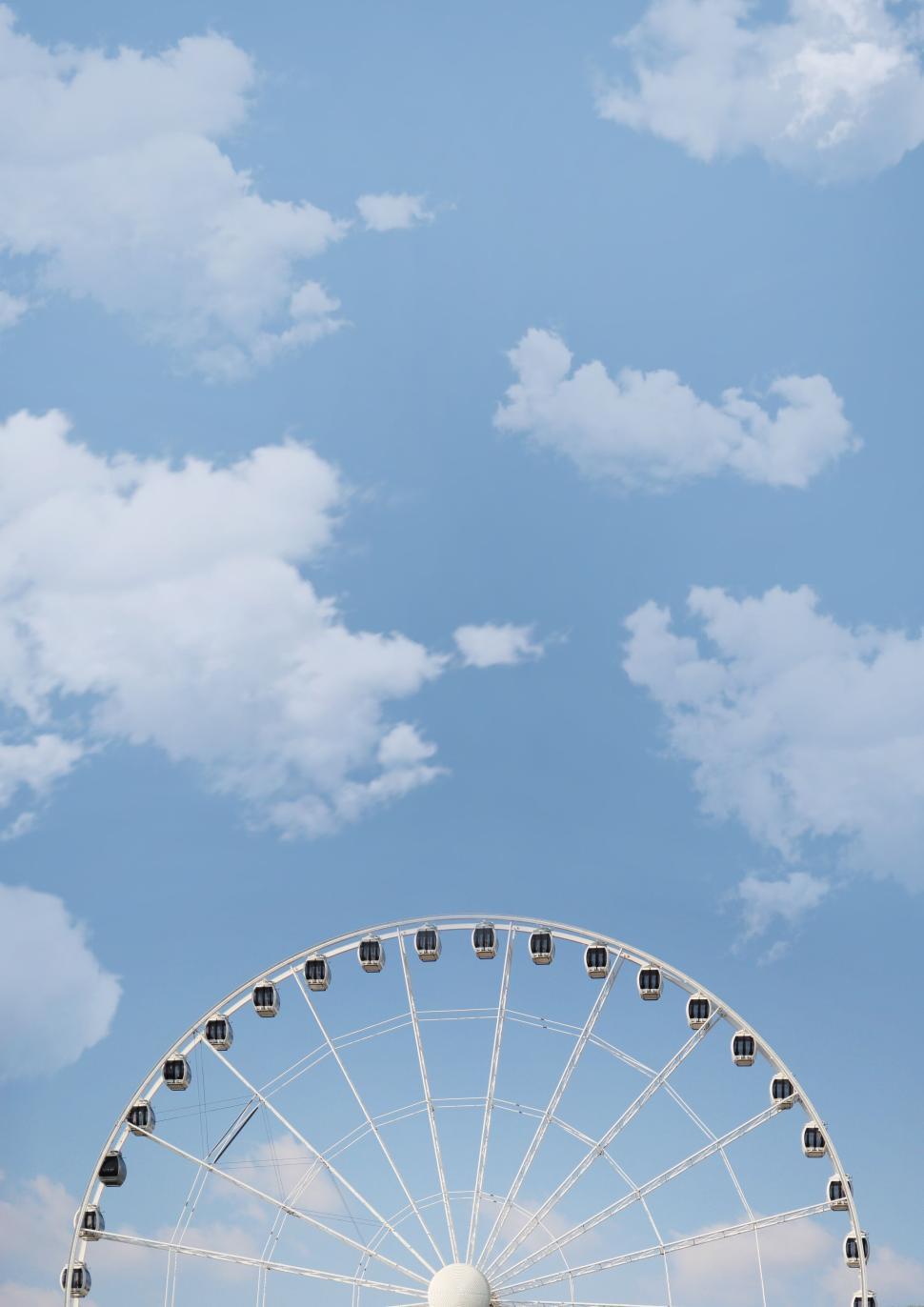 Free Image of Large Ferris wheel against a clear blue sky view 