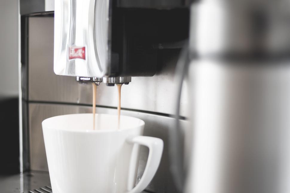 Free Image of Freshly brewed coffee pouring into white cup. 