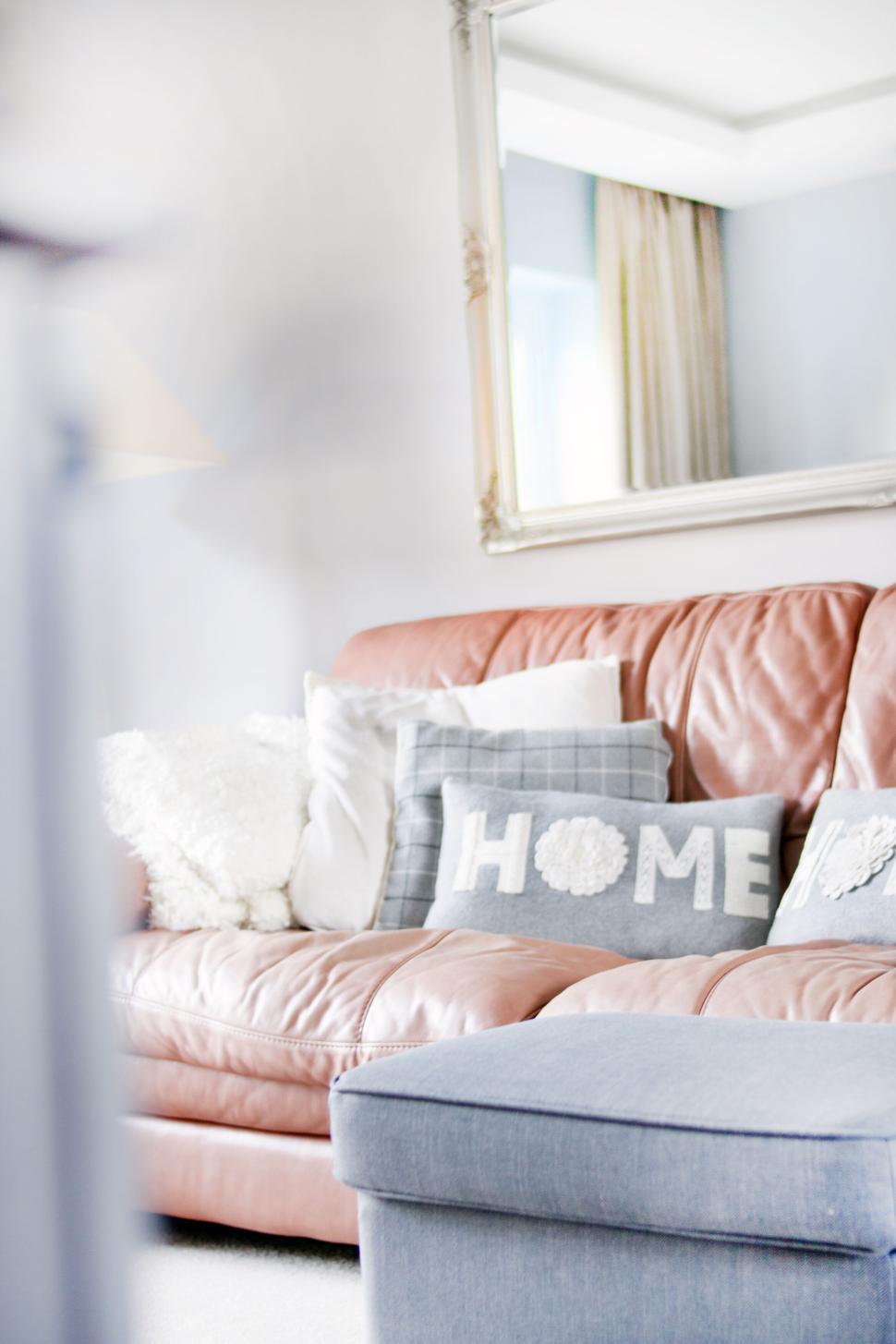 Free Image of Cozy living room with leather sofa and pillows that say HOME 