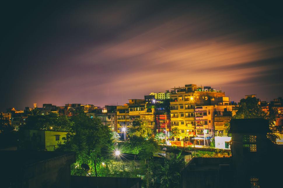 Free Image of Night cityscape with illuminated buildings and sky 