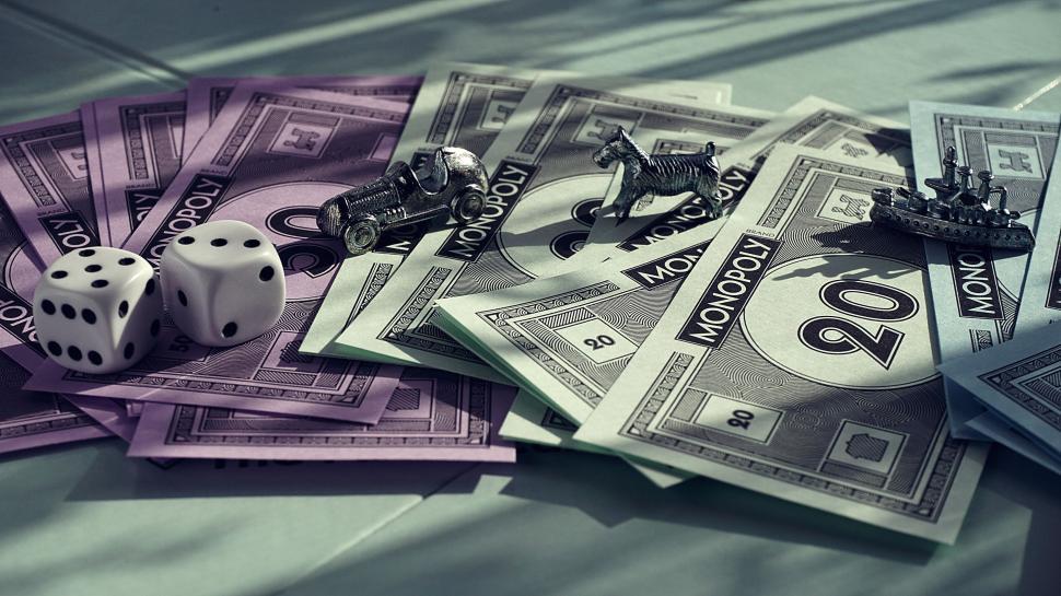 Free Image of Classic Monopoly game money and pieces on table. 