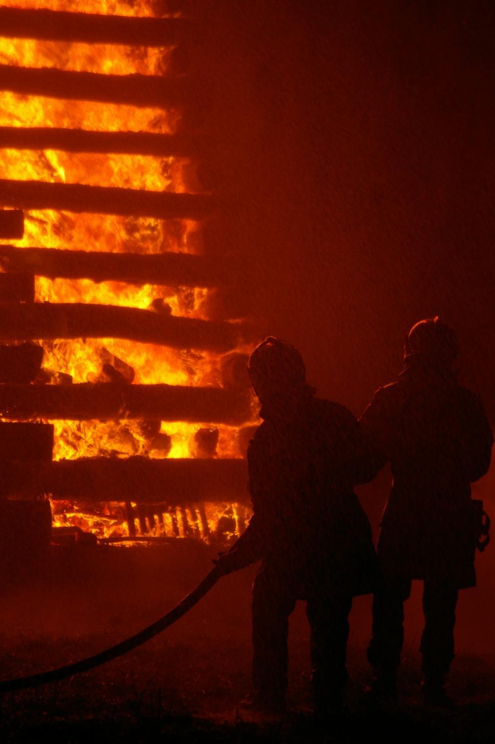 Free Image of People Standing in Front of Fire 