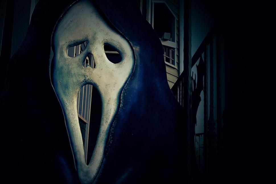 Free Image of Scary ghost mask in dark area of a house with stairs. 