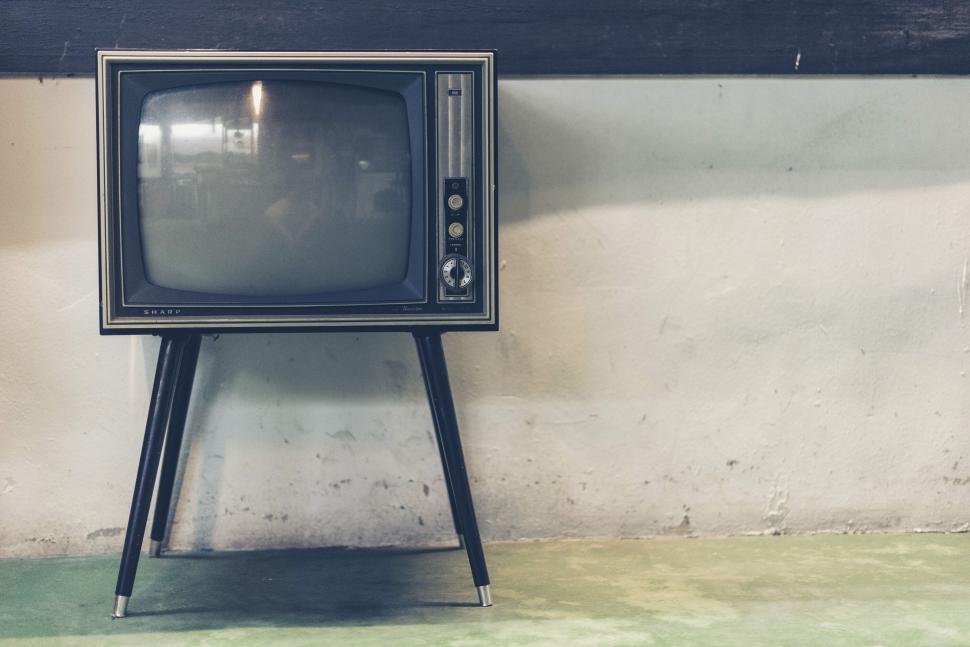 Free Image of Vintage television against a simple indoor wall. 