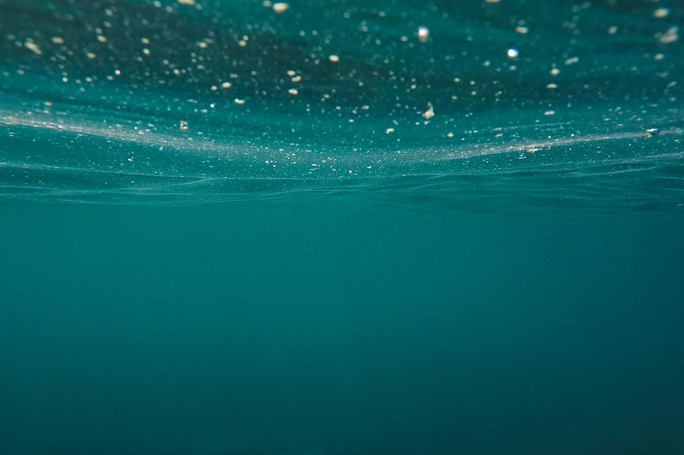 Free Image of Underwater scene with particles floating in the water 