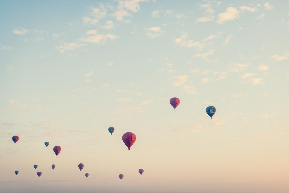 Free Image of Hot air balloons in the sky at sunrise with clouds 