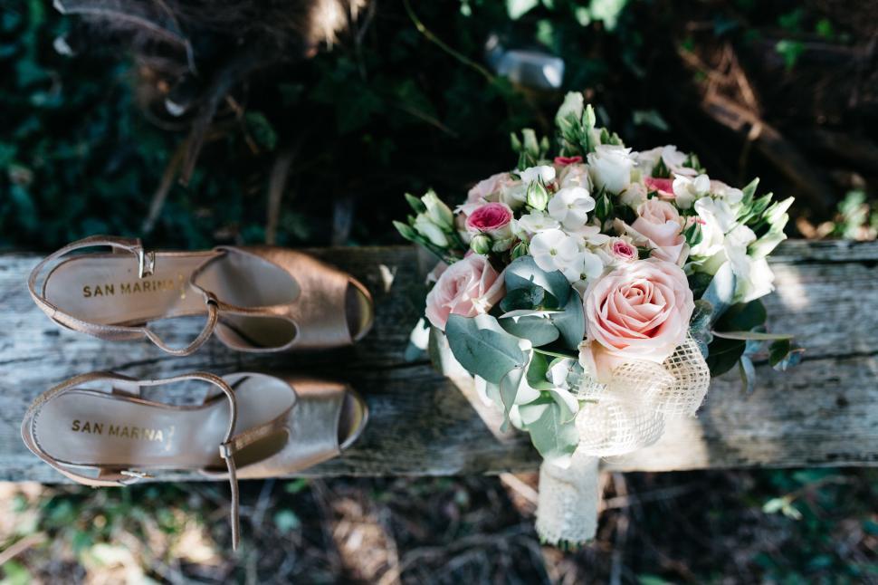 Free Image of Elegant bridal items including shoes and flowers 