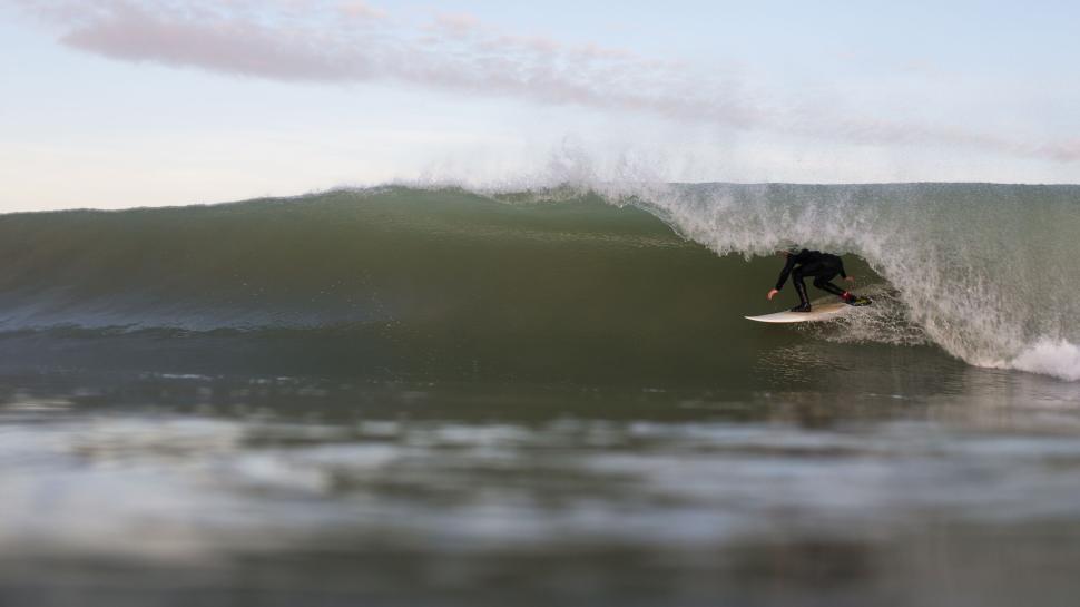 Free Image of Surfer riding a powerful wave in the ocean 