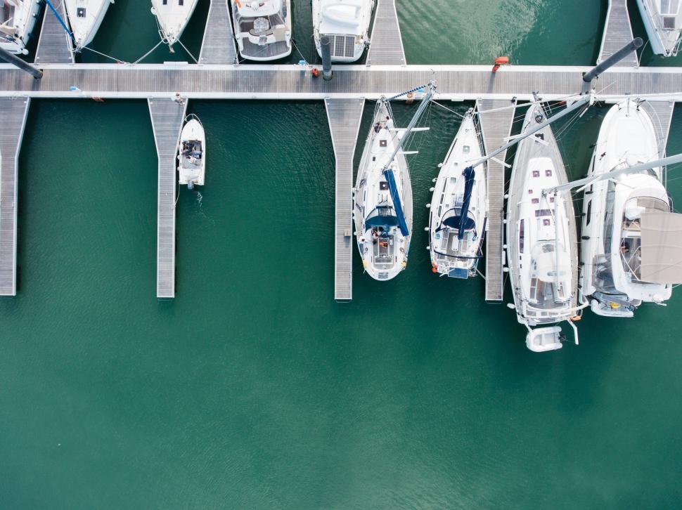 Free Image of Aerial view of a marina with boats docked at piers 
