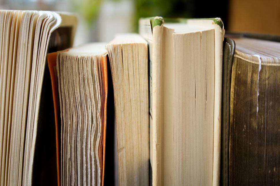 Free Image of Collection of books with worn pages and varying sizes. 