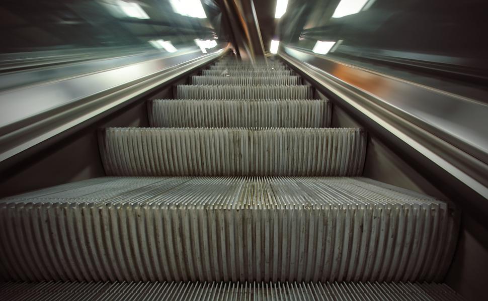 Free Image of Moving escalator steps blur from high speed in subway. 