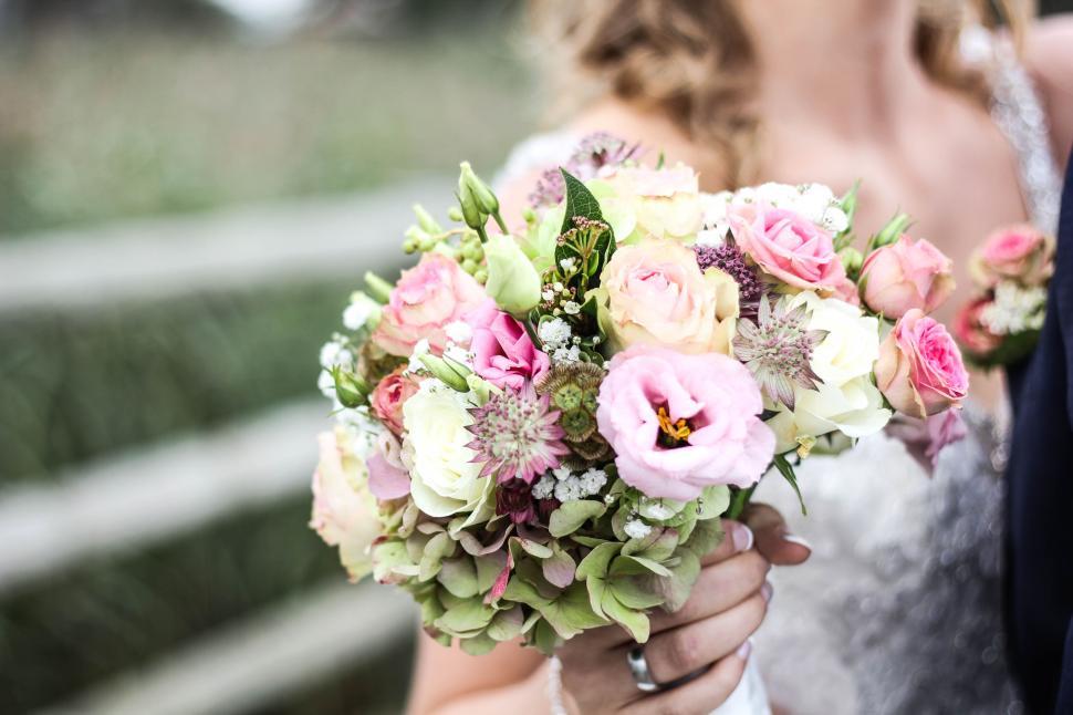 Free Image of Bride holding colorful floral bouquet on wedding day. 