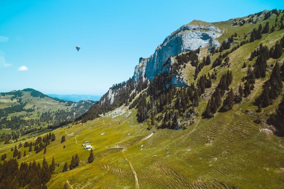 Free Image of Scenic landscape with mountain and hot air balloon view. 