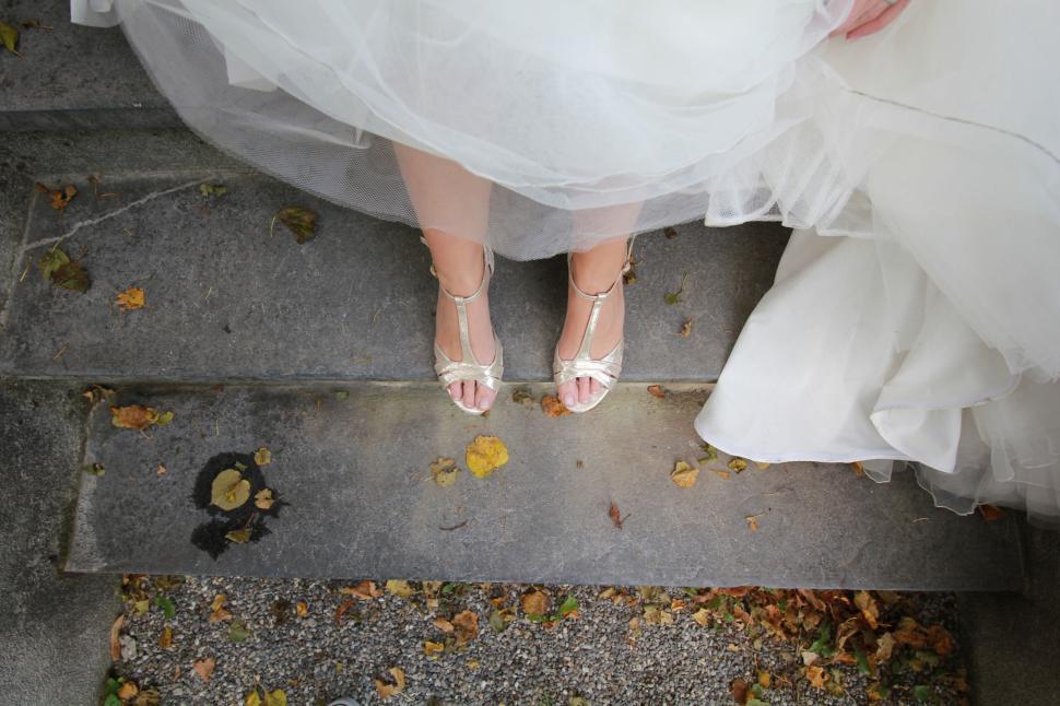 Free Image of Bride standing on steps showing elegant wedding Shoes. 