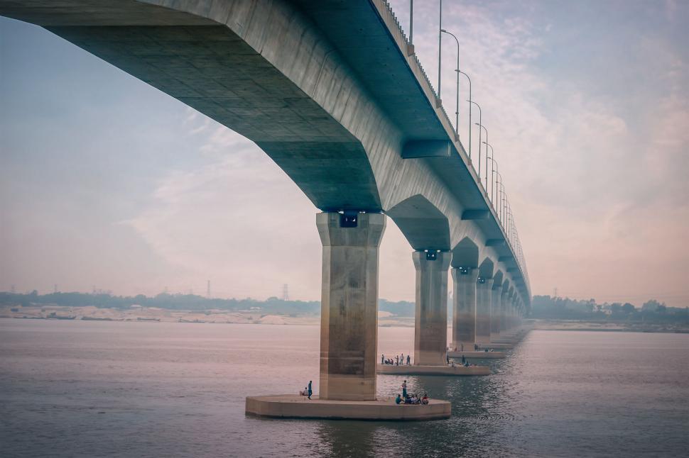 Free Image of Modern bridge structure extending over a wide river 