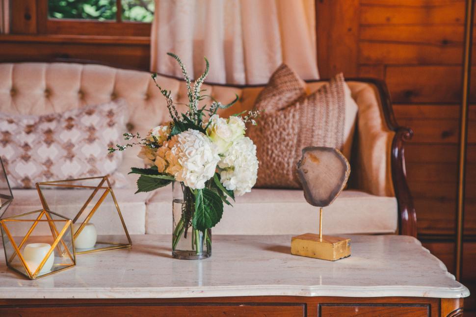 Free Image of Elegant living room with a floral arrangement on table. 