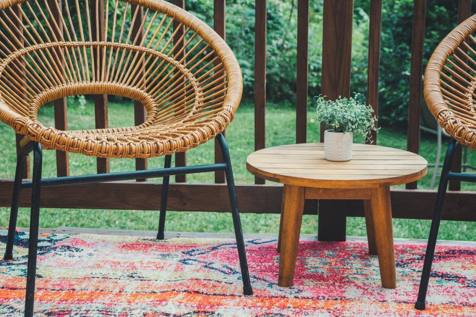 Free Image of Outdoor patio with wicker chairs and small table 