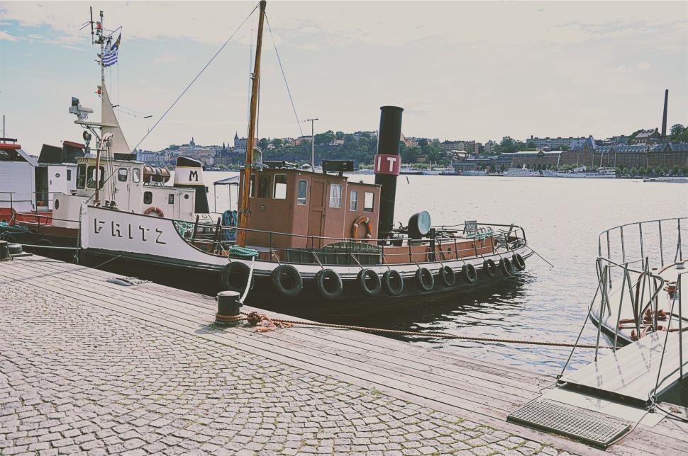 Free Image of Boat named Fritz docked peacefully at a waterfront 