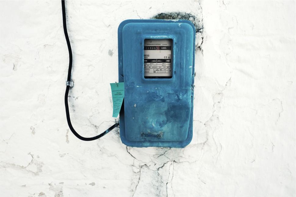 Free Image of Blue utility meter box mounted on a cracked wall 