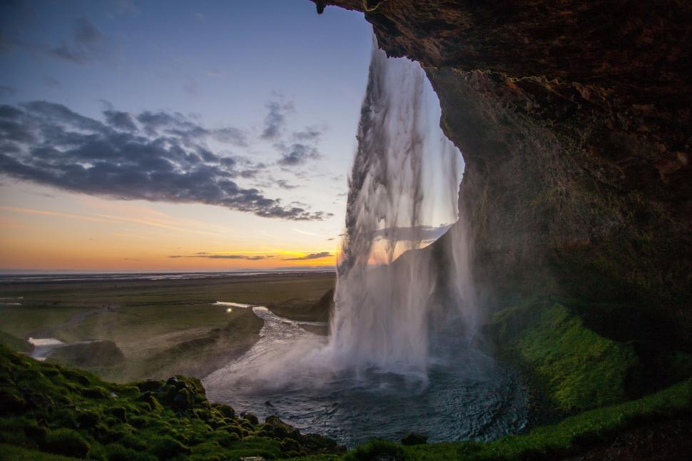 Free Image of Grand waterfall cascading from a cliff into a pool below 
