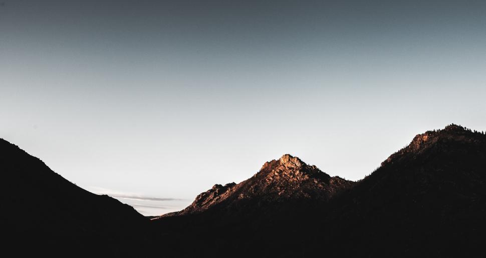Free Image of Mountainous landscape with peaks at sunrise twilight. 