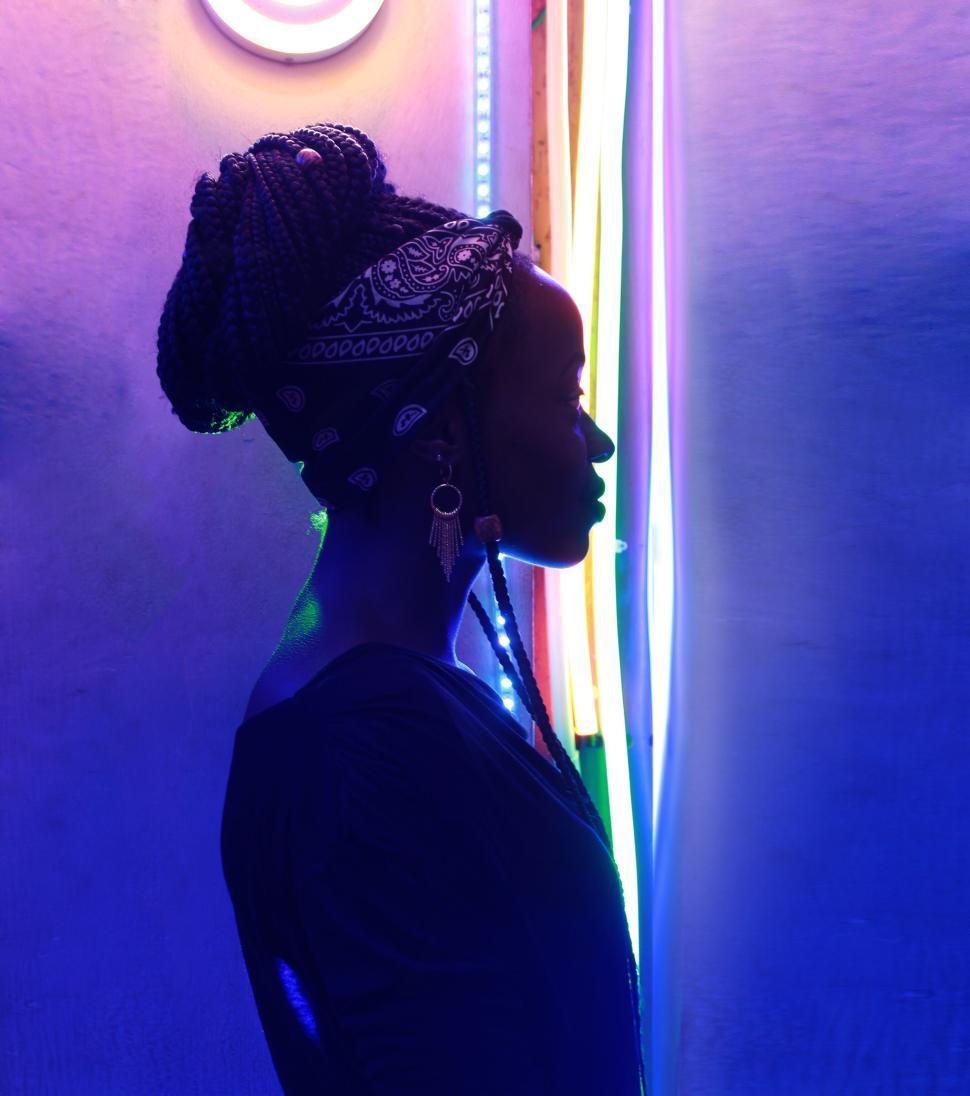 Free Image of Silhouetted woman in colorful neon light background 